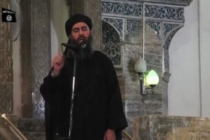 Abu Bakr al-Baghdadi at a mosque in the centre of Iraq's second city, Mosul, according to a video recording posted on the Internet on July 5, 2014, in this still image taken from video.  <br/>REUTERS/Social Media Website via Reuters TV