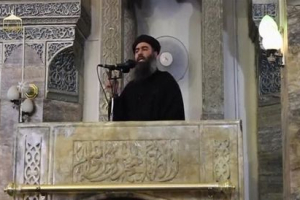 A man purported to be the reclusive leader of the militant Islamic State Abu Bakr al-Baghdadi has made what would be his first public appearance at a mosque in the centre of Iraq's second city, Mosul, according to a video recording posted on the Internet on July 5, 2014, in this still image taken from video.  <br/>REUTERS/Social Media Website via Reuters TV