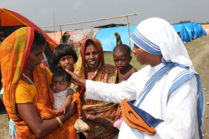 Sister Leo Therese, a member of the Missionaries of Charity, greets Majoni Bibi, holding her child at a refugee camp in early October in Basagaon, India. <br/>AP photo