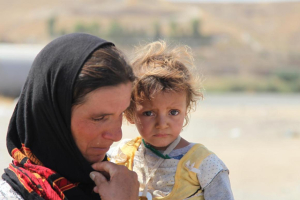 A Yazidi woman who fled Sinjar Mountain re-enters Iraq from Syria at a border <br/>UNICEF