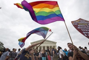 Supporters of gay marriage wave the rainbow flag after the U.S. Supreme Court ruled on Friday that the U.S. Constitution provides same-sex couples the right to marry at the Supreme Court in Washington June 26, 2015.  <br/>REUTERS/Joshua Roberts