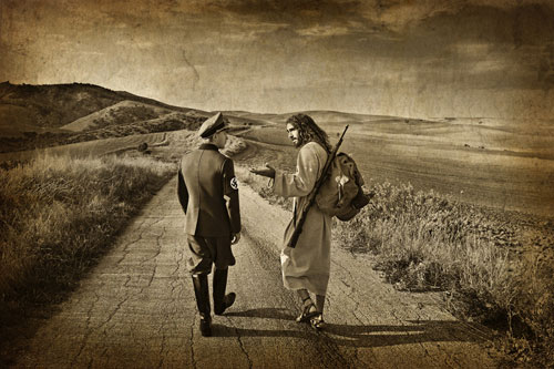 In the photo entitled “The Second Mile,” Jesus is shown walking and talking alongside a Nazi soldier. The messiah is carrying the soldier’s backpack as well as his gun. “Jesus’ teachings on this subject (forgiveness) were revolutionary: ‘Love your enemies as yourself. Pray for those who persecute you. Forgive people seventy times seven.’ Jesus reminds us that, just as God forgives us, we are expected to do the same for others. <br/>(Photo: Journeys With the Messiah)