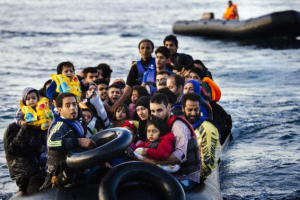 Migrants and refugees arrive on a dinghy on the Greek island of Lesbos on October 14 . <br/>AP photo
