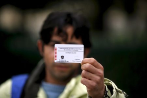 Omar, a 27-year-old cook originally from Deraa, the cradle of the Syrian uprising against Bashar Al-Assad, shows the back of his Austrian migrant card in Traiskirchen, Austria, October 13, 2015.  <br/>REUTERS/Leonhard Foeger