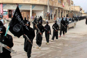 Fighters from the al Qaeda-linked Islamic State of Iraq and the Levant (ISIL) or Islamic State of Iraq and Syria (ISIS), now called the Islamic State group, marching in Raqqa, Syria. <br/> (AP Photo/Militant Website, File)