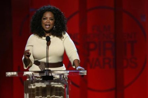 Entertainer and producer Oprah Winfrey arrives on stage to introduce a clip from her Best Feature nominated film 