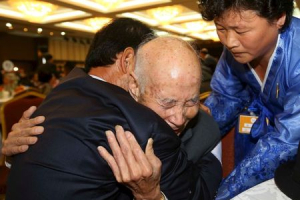 North Korean Chae Hoon Sik (C), 88, reacts as he meets his South Korean relative Chae Hee-yang, 65, during the separated family reunions at Mount Kumgang resort, North Korea, October 20, 2015.  <br/>REUTERS/KOREA POOL/Yonhap