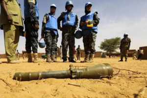 Peace keepers from the United Nations Hybrid Operation in Darfur (UNAMID) look at an RPG-7 projectile  <br/>Reuters