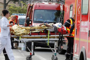 Rescue workers carry a injured person on a stretcher during rescue operations near the site where a coach carrying members of an elderly people's club collided with a truck outside Puisseguin near Bordeaux, western France, October 23, 2015. <br/> REUTERS/Regis Duvignau