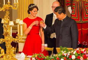The Chinese national anthem played as the guests, assembled at Buckingham Palace's lavishly decorated ballroom, rose for a toast to Xi Jinping and his wife, pictured Kate and Mr Xi toast the visit. PA <br/>