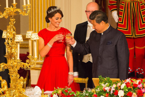 The Chinese national anthem played as the guests, assembled at Buckingham Palace's lavishly decorated ballroom, rose for a toast to Xi Jinping and his wife, pictured Kate and Mr Xi toast the visit. PA <br/>