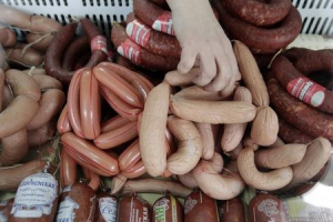 A vendor sells sausages prepared at a local sausage shop of the 