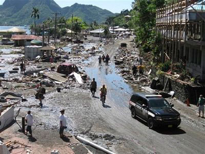 People walk among a scene of devastation following a powerful quake, in Pago Pago village, on American Samoa Tuesday, Sept. 29, 2009. <br/>(Photo: AP / SamoaNews.com, Ausage Fausia)