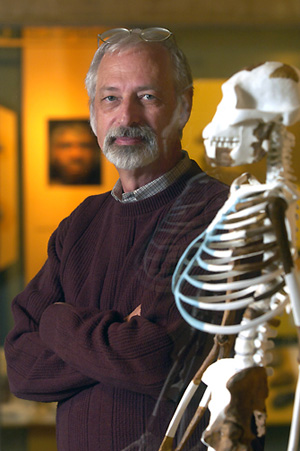 Dr. C. Owen Lovejoy, Kent State University professor of anthropology, stands next to the reconstructed skeleton of <br/>(Photo: Kent State University)