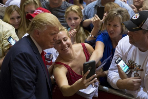 Republican presidential candidate Donald Trump takes photos with supporters after a campaign rally at Burlington Memorial Auditorium in Burlington, Iowa, October 21, 2015.  <br/>Reuters