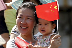 A woman and her baby wait on the street for a military parade marking the 70th anniversary of the end of World War Two, in Beijing, China, in this September 3, 2015 file photo.  <br/>REUTERS/Kim Kyung-Hoon/Files