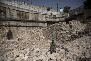 An Israeli antiquity authority worker removes dust at a site that archaeologists say contains the remnants of an ancient Greek fortress, outside the walled Old City of Jerusalem November 3, 2015.  <br/>Reuters