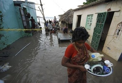 Flood victims collect reusable belongings from their damaged houses in Vijayawada in Andhra Pradesh state 285 Kilometers (178 miles) from Hyderabad, India, Thursday, Oct. 8, 2009. Thousands among the legions of southern Indians displaced by a week of flooding trickled back to their homes and farms to survey the damage left by a natural disaster that killed at least 269 people, officials said Wednesday. <br/>(Photo: AP Images / Mahesh Kumar A.)