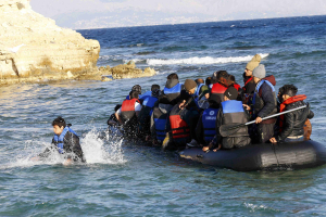 Refugees aboard a dinghy sail off for the Greek island of Chios as they try to travel from the western Turkish coastal town of Cesme, in Izmir province, Turkey, November 4, 2015.  <br/>Reuters
