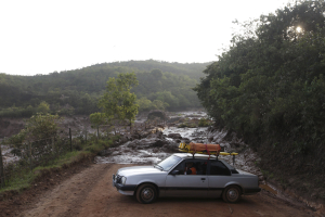 Rescue workers drive on a road blocked with mud after a dam owned by Vale SA and BHP Billiton Ltd burst in Mariana, Brazil, November 6, 2015.  <br/>Reuters