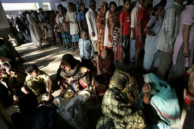 Slum and street dwellers wait for food at a distribution center of the Missionaries of Charity, the order founded by Mother Teresa, in Calcutta, India, Wednesday, Oct. 14, 2009. Albania wants the remains of Nobel Peace laureate Mother Teresa to be returned to the country, the prime minister said last week. <br/>AP Images / Bikas Das