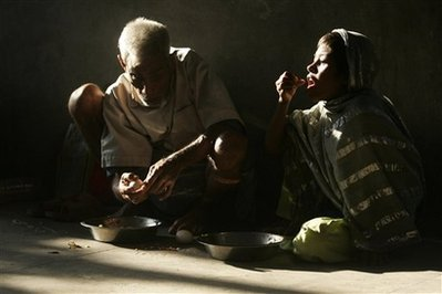 Street dwellers eat food at a distribution center of the Missionaries of Charity, the order founded by Mother Teresa, in Calcutta, India, Wednesday, Oct. 14, 2009. <br/>(Photo: AP Images / Bikas Das)