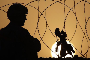A U.S. Army soldier with the 1-320 Field Artillery Regiment, 101st Airborne Division, keeps watch at sunset from Combat Outpost Terra Nova in the Arghandab Valley north of Kandahar July 18, 2010. <br/>Reuters
