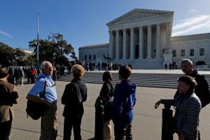 Visitors wait in line at the U.S. Supreme Court building to watch arguments on the first day of the court's new term in Washington, October 5, 2015.  <br/>Reuters