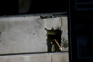 A forensic expert inspects the apartment raided by French Police special forces earlier in Saint-Denis, near Paris, France, November 18, 2015 during an operation to catch fugitives from Friday night's deadly attacks in the French capital. <br/>Reuters