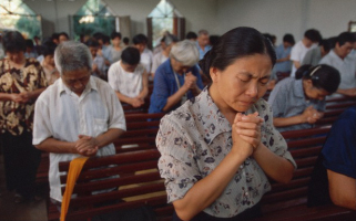 Worshipers pray at an underground church in China. <br/>AP photo