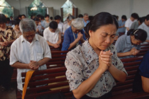 Worshipers pray at an underground church in China. <br/>AP photo