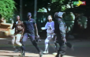 Still image from video show a hostage rushed out from the Radisson hotel in Bamako, Mali, November 20, 2015.  <br/>Reuters