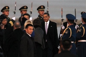 U.S. President Barack Obama, center, walks past the Chinese guards of honor upon arrival at the Beijing International Airport in Beijing, China, Monday, Nov. 16, 2009. <br/>AP Images / Andy Wong