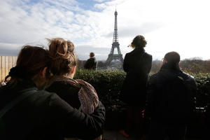 People observe a minute of silence at the Trocadero in front the Eiffel Tower to pay tribute to the victims of the series of deadly attacks on Friday in Paris, France, November 16, 2015. REUTERS/Philippe Wojazer <br/>