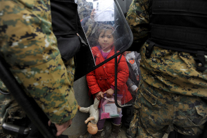 A migrant girl holds her toys as Macedonian policemen block migrants at the Greek-Macedonian borders, near the village of Idomeni, Greece November 20, 2015. Balkan countries have begun filtering the flow of migrants to Europe, granting passage to those fleeing conflict in the Middle East and Afghanistan but turning back others from Africa and Asia, the United Nations and Reuters witnesses said on Thursday. REUTERS/Alexandros Avramidis <br/>
