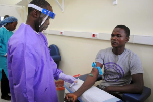 A healthcare worker takes a blood sample from an Ebola survivor as part of a study on the disease, in Monrovia, Liberia, June 17, 2015.  <br/>Reuters