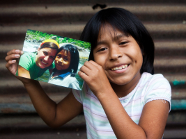 Ten-year-old Elizabeth holds up a photo of her sponsor, Elizabeth Mellado. <br/>Compassion International