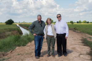 Franklin Graham, Greta Van Susteren, and John Coale stand in front of the new irrigation system. <br/>Samaritan's Purse