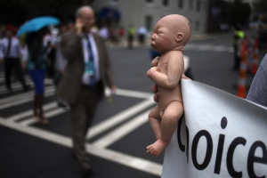 A pro-life activist holds a doll and banner while advocating his stance on abortion near the site of the Democratic National Convention in Charlotte, North Carolina on September 4, 2012.  <br/>REUTERS/Adrees Latif