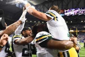Green Bay Packers quarterback Aaron Rodgers (12) celebrates with teammates after defeating the Detroit Lions at Ford Field. Green Bay won 27-23. Mandatory Credit: Tim Fuller-USA TODAY Sports<br />
 <br/>