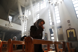 An Assyrian woman attends a Mass on March 1, 2015, inside Ibrahim al-Khalil church in Jaramana, eastern Damascus, in solidarity with the Assyrians abducted by Islamic State fighters in Syria. Photo courtesy of REUTERS/Omar Sanadiki <br/>