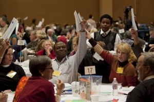 Delegates raise their ballots for Bishop Suffragan during the 114th Annual Meeting of the Diocese of Los Angeles for the Episcopal Church held in Riverside, Calif., on Friday, Dec. 4, 2009. The Episcopal Diocese of Los Angeles elected the first female bishop, Rev. Diane M. Jardine Bruce, in its 114-year history. <br/>AP Images / Francis Specker