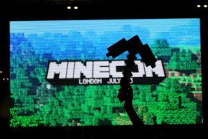 A fan of video game Minecraft waves a foam pick-axe in front of a screen display at the Minecon convention in London July 4, 2015.<br />
REUTERS/MATTHEW TOSTEVIN<br />
 <br/>Reuters