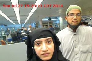 Tashfeen Malik, (L), and Syed Farook are pictured passing through Chicago's O'Hare International Airport in this July 27, 2014 handout photo obtained by Reuters December 8, 2015.  <br/>REUTERS/US Customs and Border Protection/Handout via Reuters