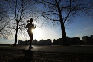 A woman jogs along the Charles River on an early spring evening in Boston, Massachusetts. Reuters <br/>