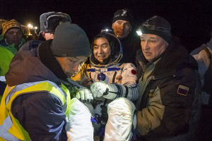 Ground personnel carry International Space Station (ISS) crew member Kimiya Yui of Japan after a landing near the town of Dzhezkazgan (Zhezkazgan), Kazakhstan, December 11, 2015. REUTERS/GCTC/Andrey Shelepin/Pool<br />
 <br/>