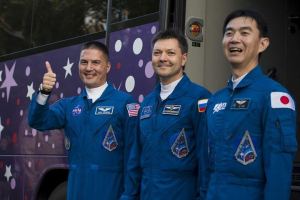 Expedition 44 crew members, Soyuz Commander Oleg Kononenko (C) of the Russian Federal Space Agency (Roscosmos), Flight Engineer Kjell Lindgren (L) of NASA, and Flight Engineer Kimiya Yui (R) of the Japan Aerospace Exploration Agency (JAXA), wave farewell to family and friends as they depart the Cosmonaut Hotel to suit-up for their Soyuz launch to the International Space Station in Baikonur, Kazakhstan on July 22, 2015. REUTERS/Aubrey Gemignani/NASA/Handout via Reuters <br/>