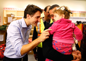 Syrian refugees are greeted by Canada's Prime Minister Justin Trudeau (L) on their arrival from Beirut at the Toronto Pearson International Airport in Mississauga, Ontario, Canada December 11, 2015. REUTERS/Mark Blinch <br/>