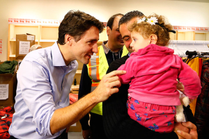 Syrian refugees are greeted by Canada's Prime Minister Justin Trudeau (L) on their arrival from Beirut at the Toronto Pearson International Airport in Mississauga, Ontario, Canada December 11, 2015. REUTERS/Mark Blinch <br/>