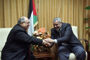 In this photo released by the office of Hamas leader, Ismail Haniyeh, Deposed Palestinian Prime Minister Ismail Haniyeh, right, shakes hand with Gaza-based Father Manuel Musalam during their meeting in Gaza City Tuesday, June 26, 2007. The ransacking of Gaza's Catholic convent and an adjacent Rosary Sisters school during Hamas' recent sweep to power broke more than wood and plaster: it signaled the end of a relatively peaceful, even if sometimes uneasy relationship between Gaza's 1.4 million Muslims and 3,500 Christians. <br/>(AP Photo/ Mohammad Alostaz, HO)